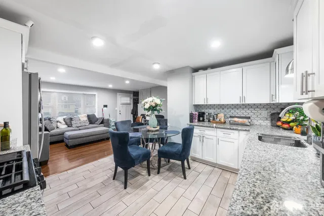 a kitchen with a dining table chairs and living room