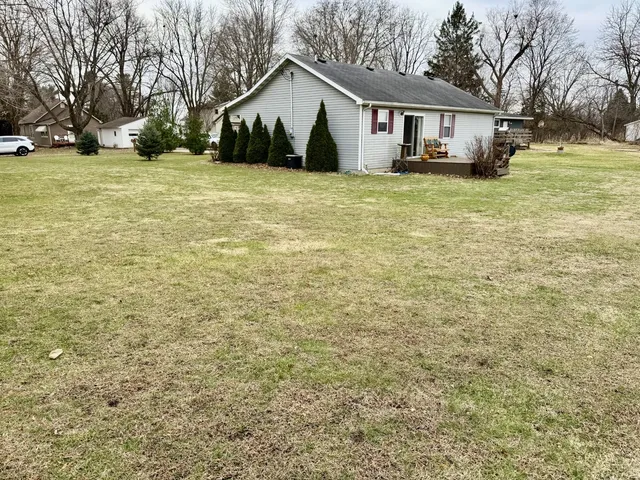 a view of a house with a yard and garage