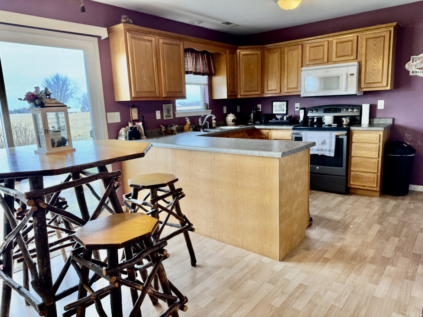 406 Edwards Street Granville, IL 61326 - Photo 6 of 13 a kitchen with stainless steel appliances granite countertop a stove a refrigerator a kitchen island a table and chairs