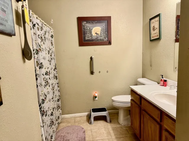 a bathroom with a sink toilet and a mirror