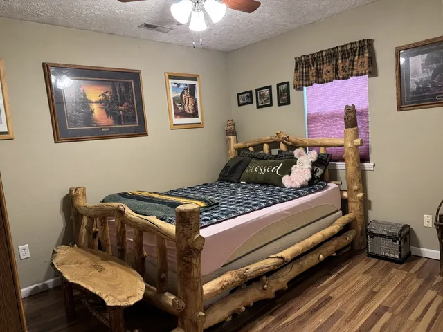 a bedroom with a bed and wooden floor