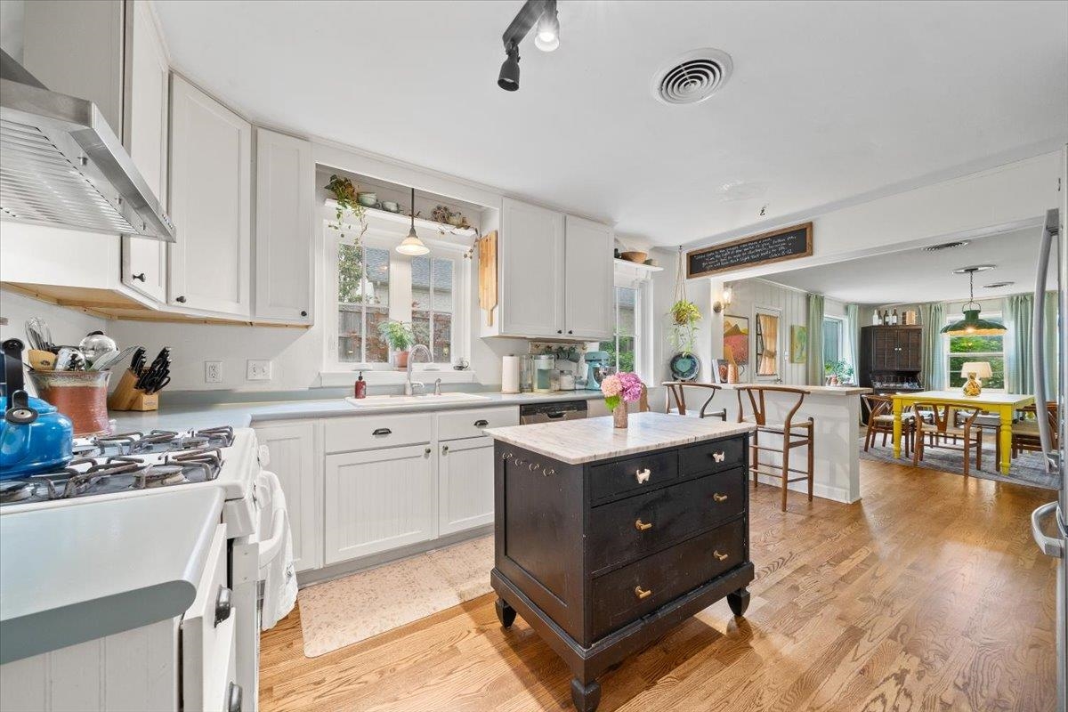 5283 Cole Road Memphis, TN 38120 - Photo 14 of 35 a kitchen with sink cabinets and wooden floor