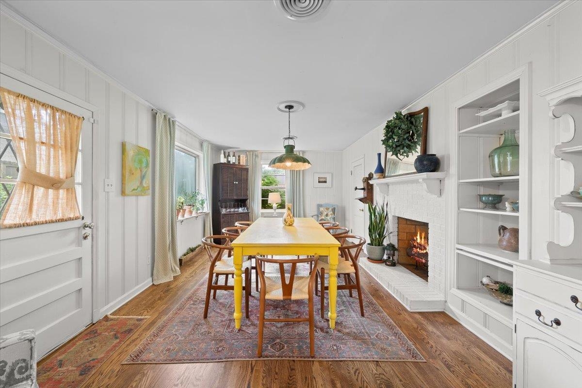 5283 Cole Road Memphis, TN 38120 - Photo 20 of 35 a dining room with furniture a fireplace and wooden floor