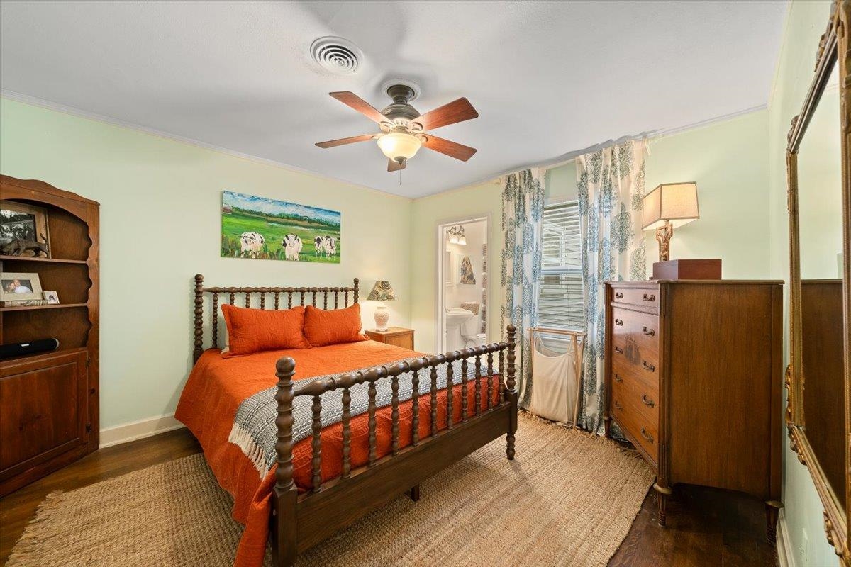 5283 Cole Road Memphis, TN 38120 - Photo 22 of 35 a bedroom with a bed and a chandelier