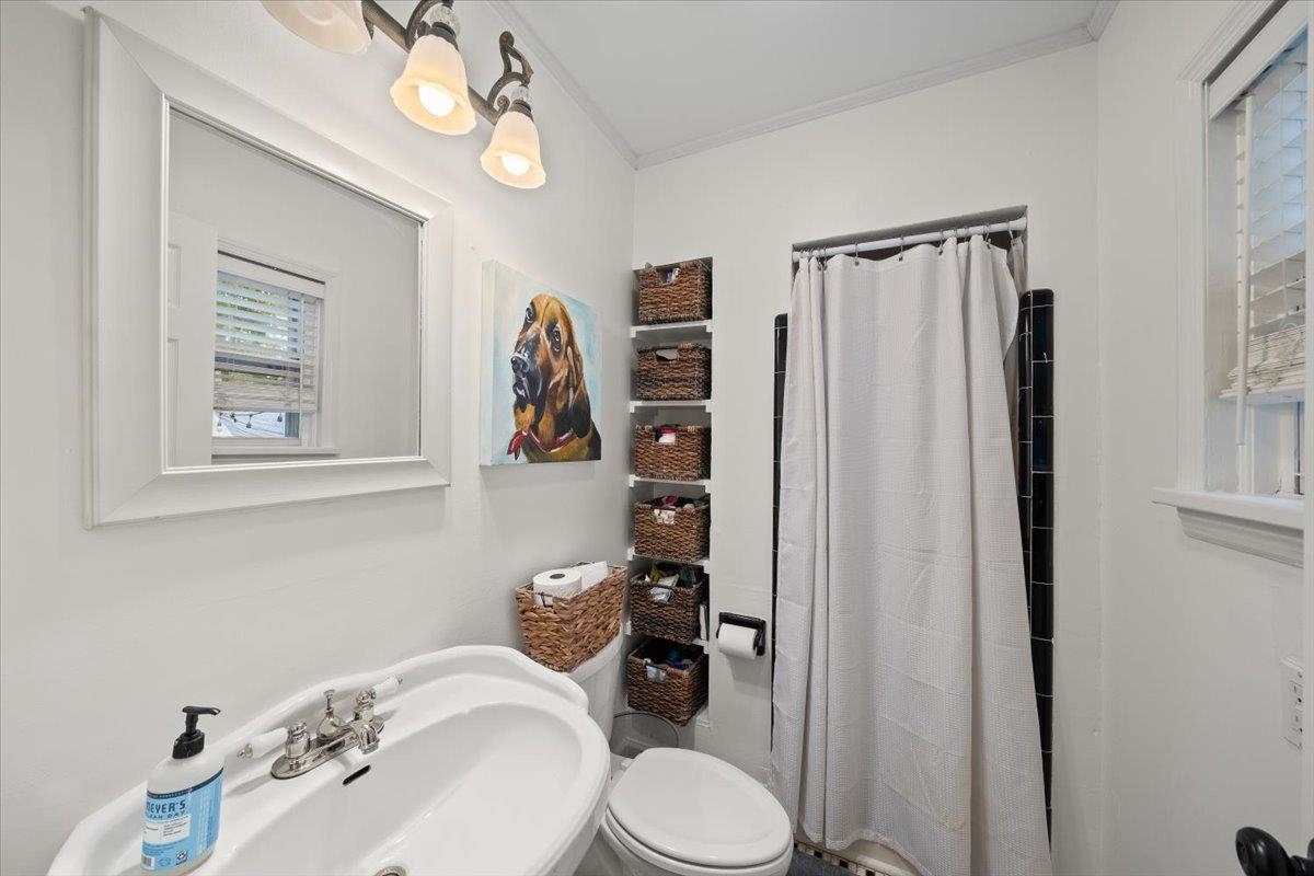 5283 Cole Road Memphis, TN 38120 - Photo 23 of 35 a bathroom with a toilet a sink and mirror