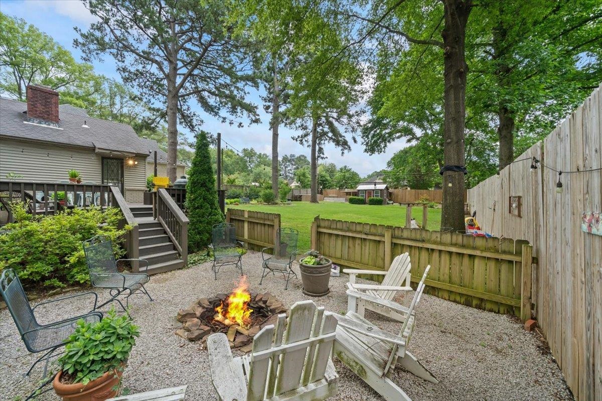 5283 Cole Road Memphis, TN 38120 - Photo 30 of 35 a view of a patio with couches chairs and a table and chairs with wooden fence