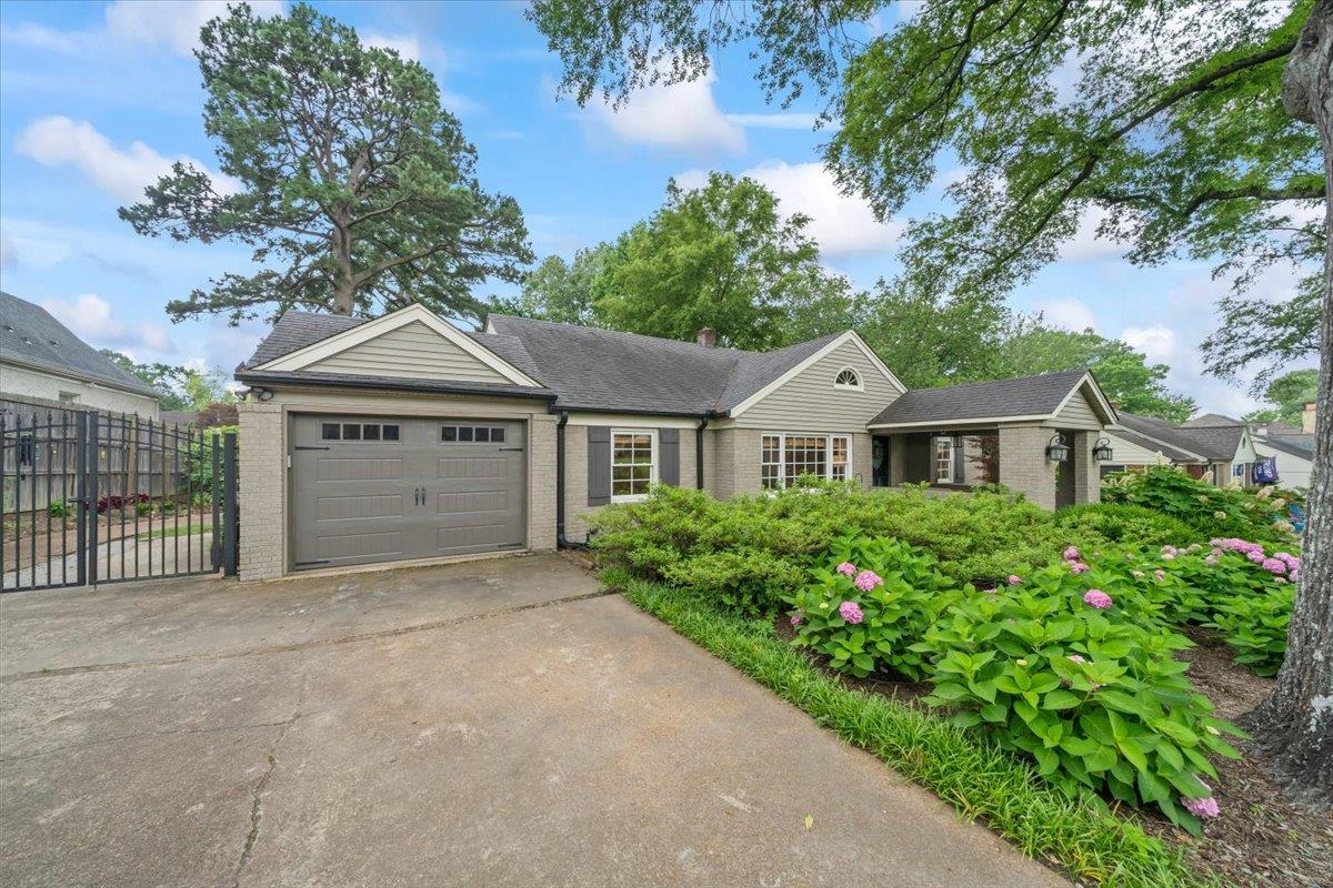 5283 Cole Road Memphis, TN 38120 - Photo 4 of 35 a front view of a house with a garden