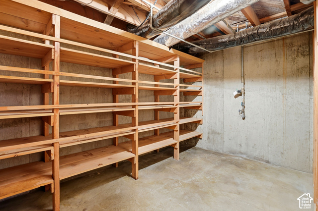 380 North 300 East Mapleton, UT 84664 - Photo 25 of 35 Extensive built-in wood shelving units, concrete walls, concrete flooring, exposed ceiling joists, and visible ductwork