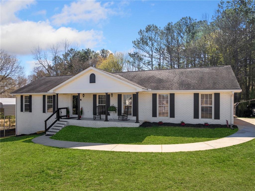 4885 Pisgah Road Cumming, GA 30028 - Photo 1 of 1 a front view of a house with a yard and trees