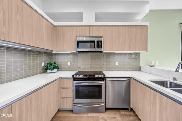 a kitchen with a sink stove and microwave