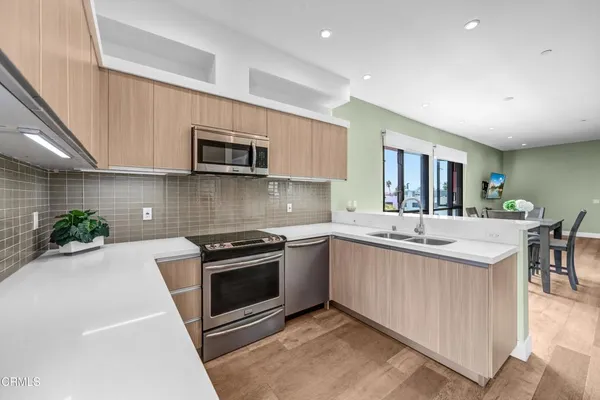 a kitchen with a sink stove and cabinets
