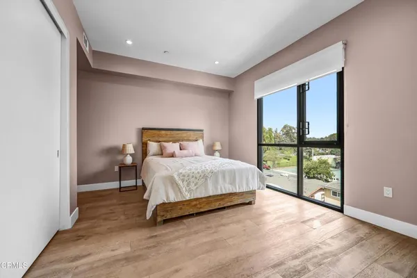 a bedroom with a large bed and a large window