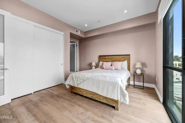 a bedroom with a bed and a flat screen tv