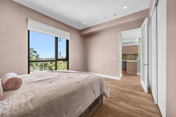 a bedroom with a bed and a large window