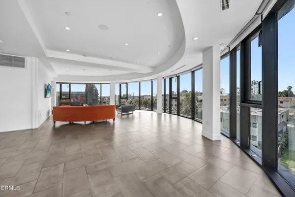 a view of a room with furniture and floor to ceiling window