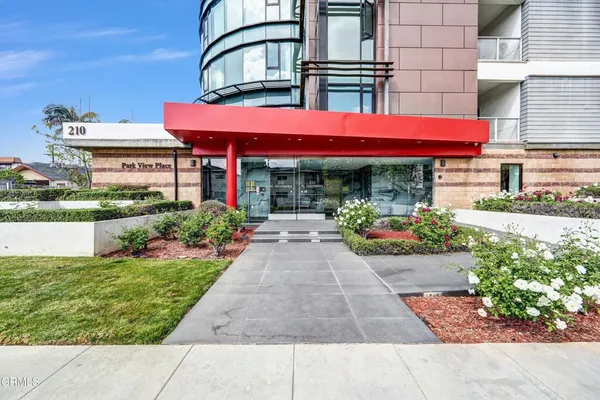 a view of building with potted plants