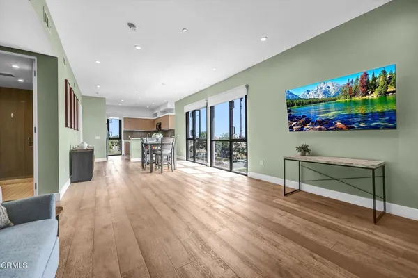 a living room with furniture and a wooden floor