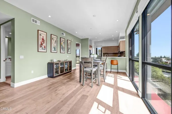 a view of a dining room with furniture window and wooden floor