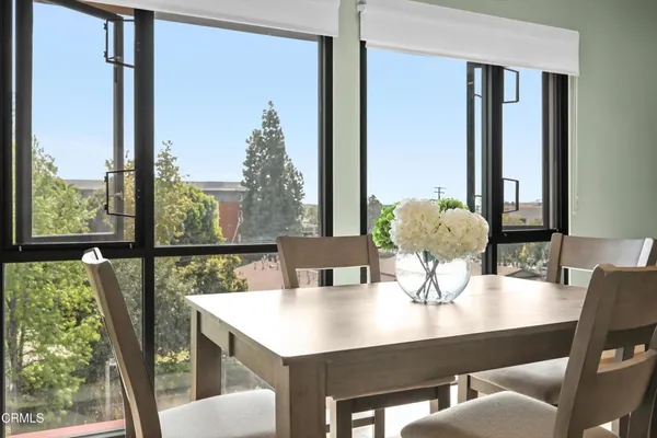 a view of a dining room with furniture window and wooden floor