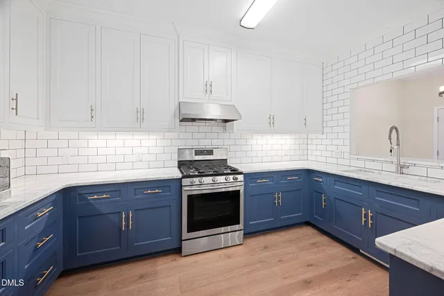 a kitchen with granite countertop wooden cabinets and stainless steel appliances