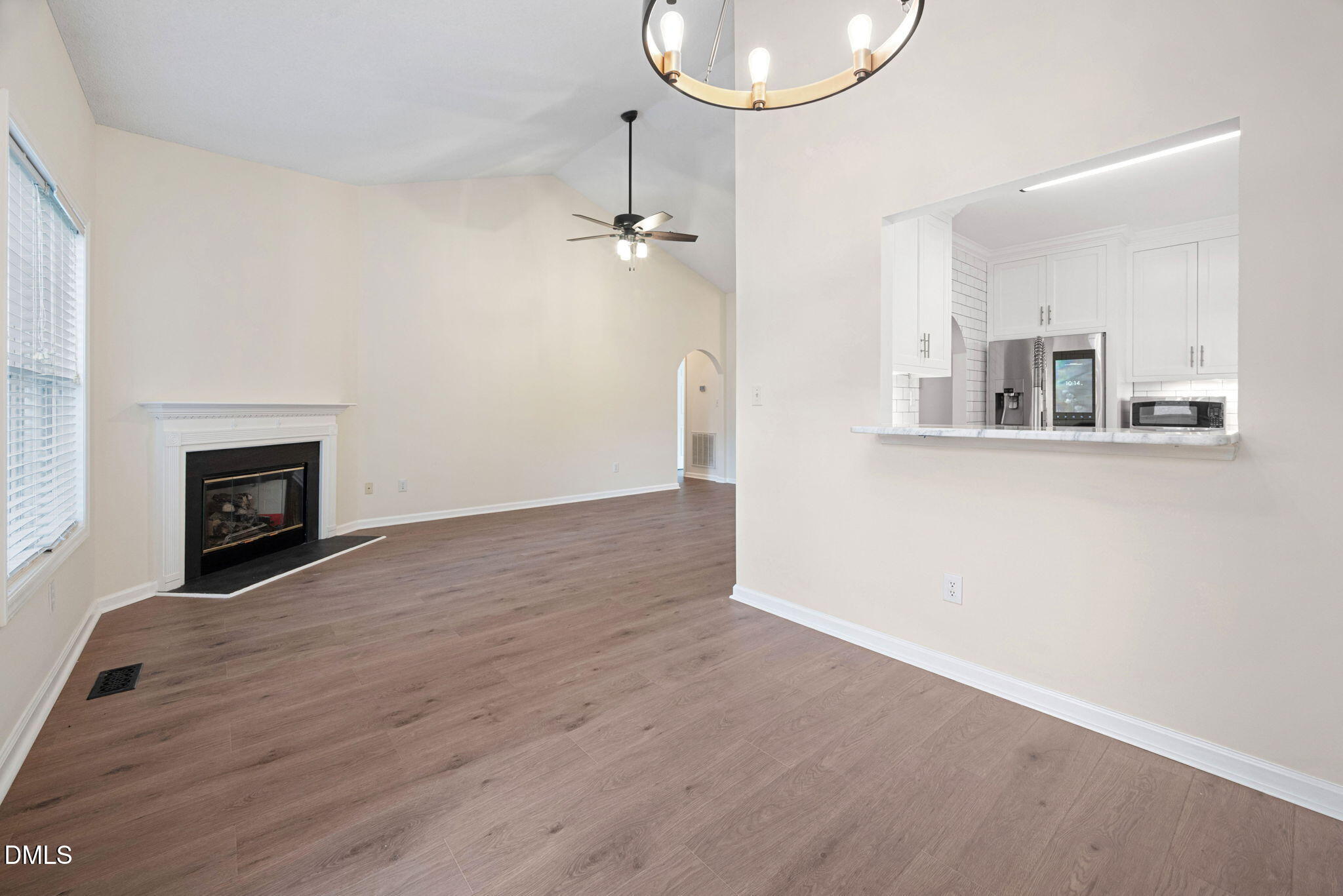 2524 Beech Gap Court Raleigh, NC 27603 - Photo 15 of 31 an empty room with wooden floor a fireplace and windows