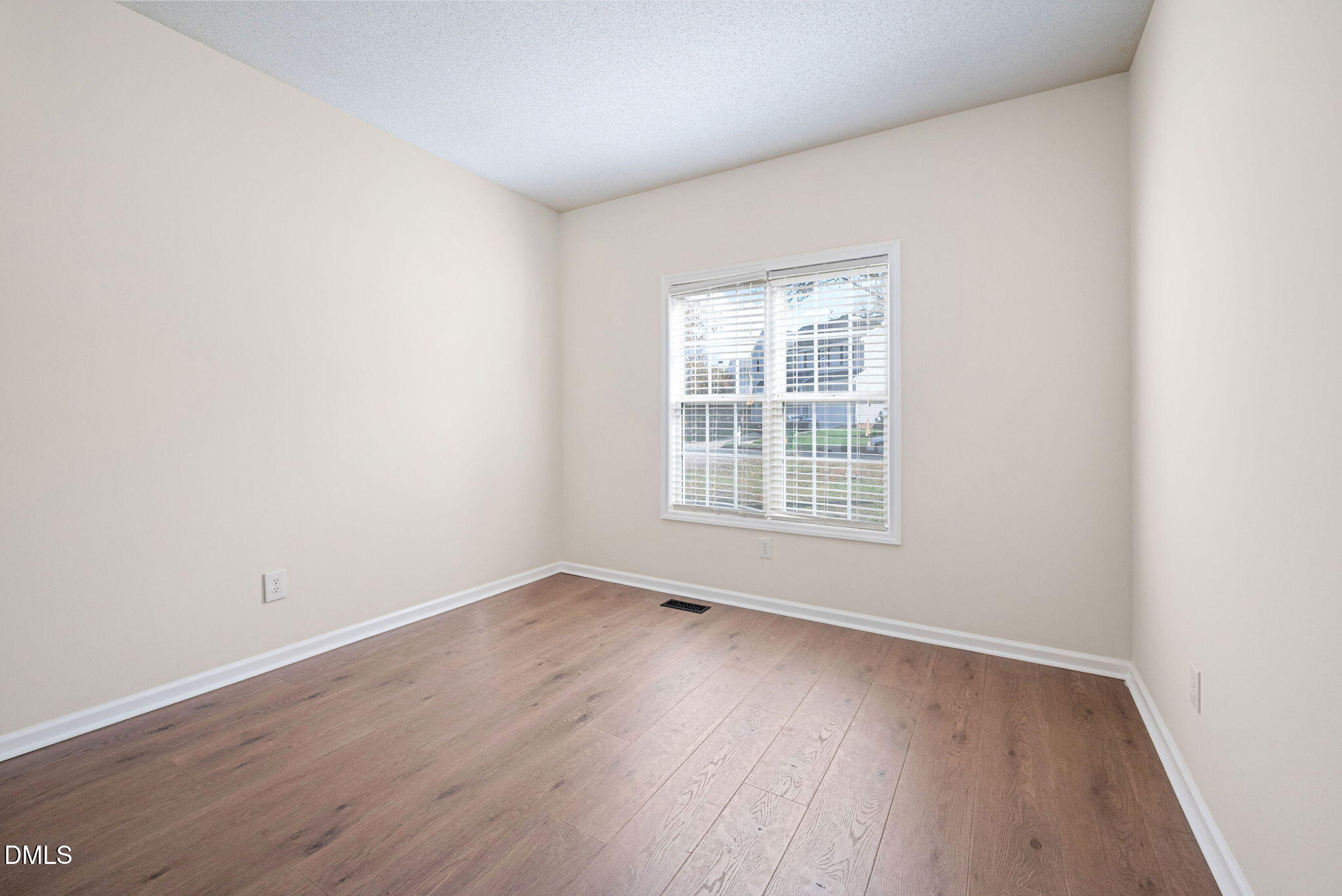 2524 Beech Gap Court Raleigh, NC 27603 - Photo 21 of 31 an empty room with wooden floor and windows