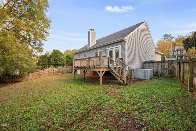 a backyard of a house with table and chairs