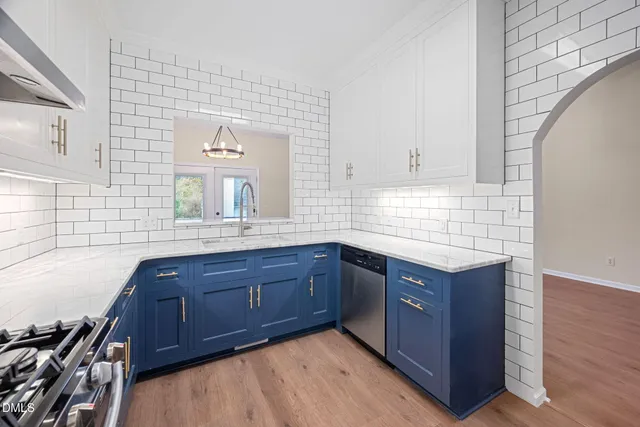 a kitchen with stainless steel appliances granite countertop wooden cabinets and a stove top oven