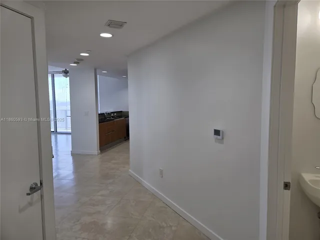 a white toilet sitting next to a small sink
