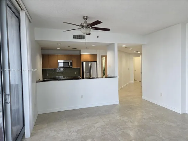 a kitchen with stainless steel appliances a refrigerator and a stove