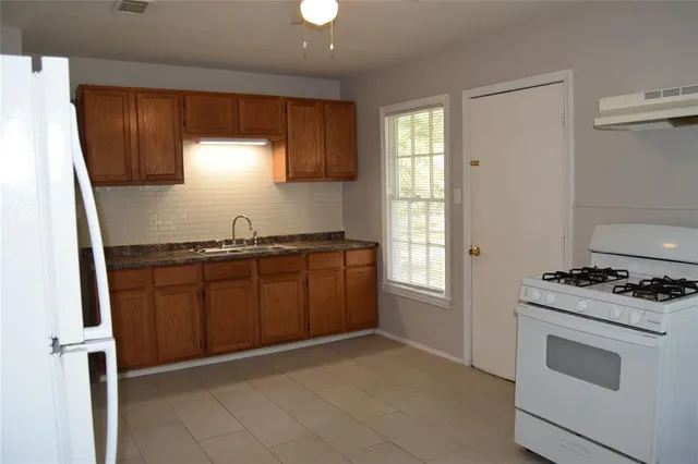 a view of a refrigerator in a kitchen