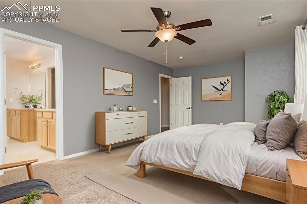 4815 Harrier Ridge Drive Colorado Springs, CO 80916 - Photo 12 of 33 Bedroom featuring light colored carpet, ceiling fan, and ensuite bathroom Virtually Staged
