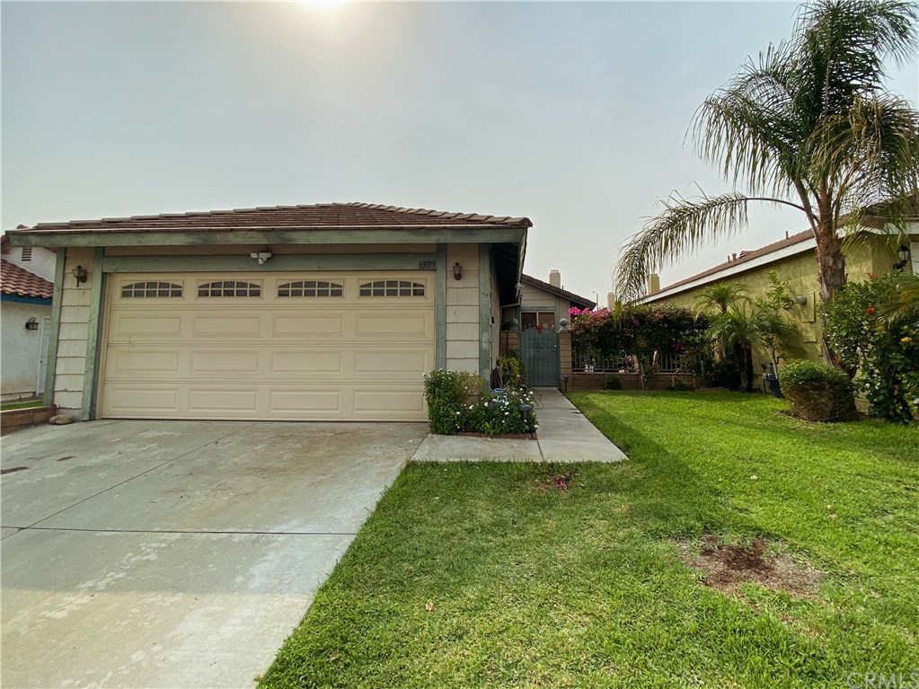 1395 North Coral Tree Road Colton, CA 92324 - Photo 1 of 1 a front view of house with yard and green space
