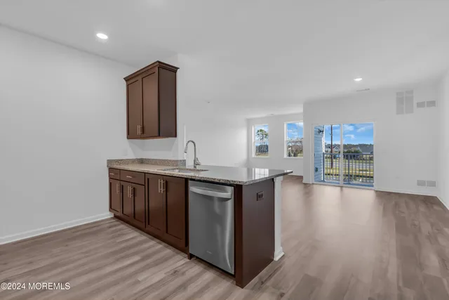 a kitchen with granite countertop a sink and cabinets