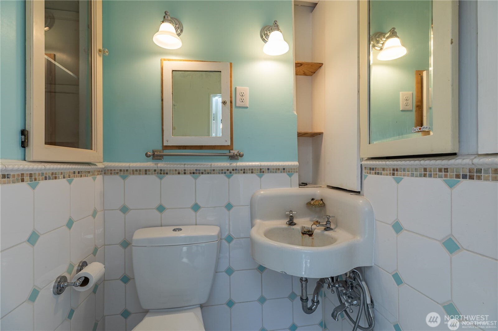 8601 36th Avenue Southwest Seattle, WA 98126 - Photo 21 of 28 a bathroom with a sink a toilet and a mirror