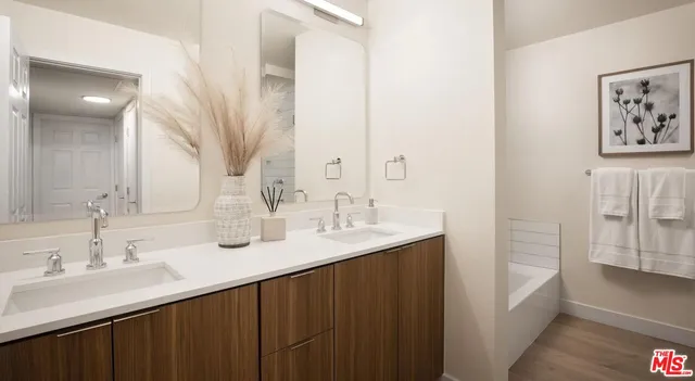 a bathroom with a double vanity sink and a mirror