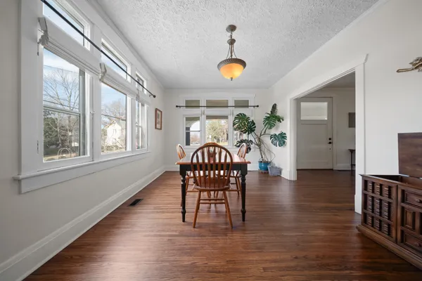 a view of a dining room with furniture and wooden floor