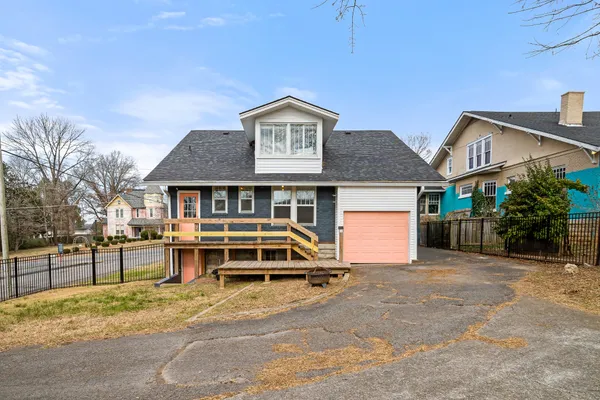 a view of house with deck and outdoor space