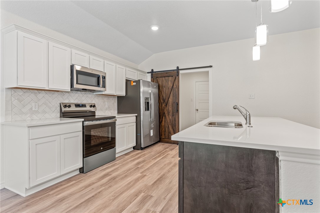 1204 Victory Ranch Trail Killeen, TX 76549 - Photo 11 of 33 a kitchen with stainless steel appliances a refrigerator sink and microwave