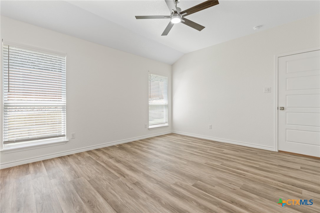 1204 Victory Ranch Trail Killeen, TX 76549 - Photo 14 of 33 a view of an empty room with wooden floor and a window