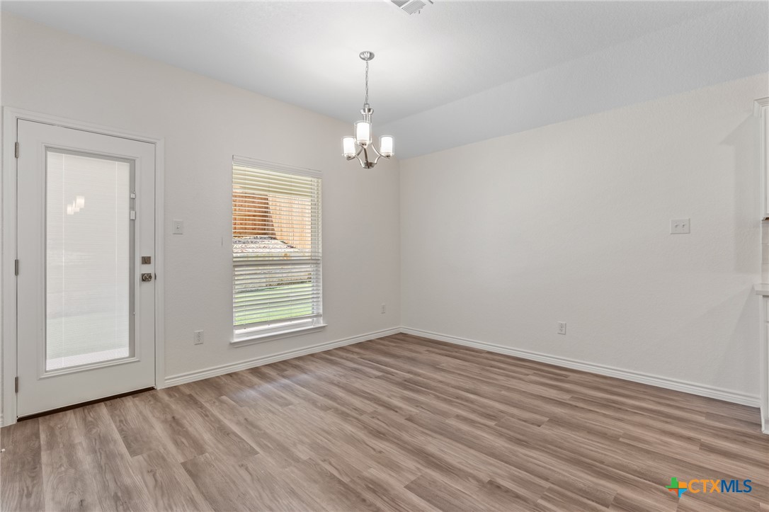 1204 Victory Ranch Trail Killeen, TX 76549 - Photo 9 of 33 wooden floor in an empty room with a window