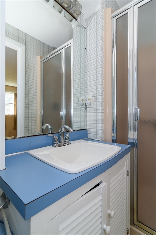 440 County Road Bourne, MA 02559 - Photo 20 of 27 a room with a table chairs and chandelier