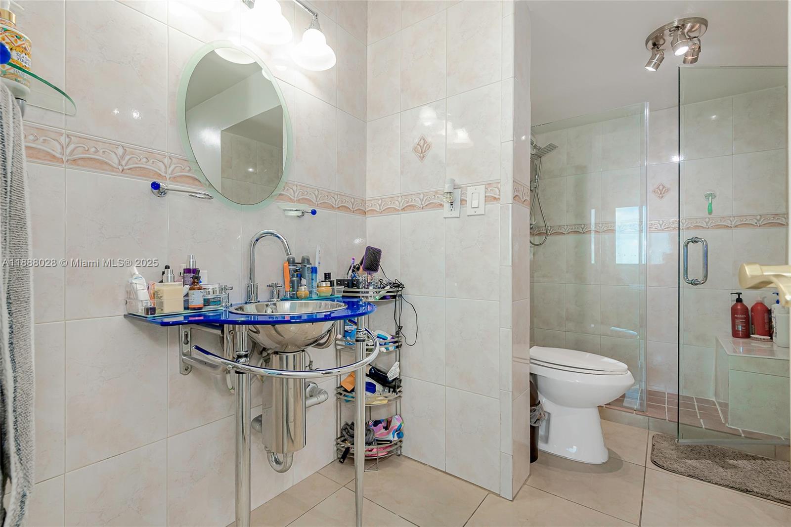7135 Collins Avenue, Unit 625 Miami Beach, FL 33141 - Photo 21 of 33 a bathroom with a sink a toilet and a mirror