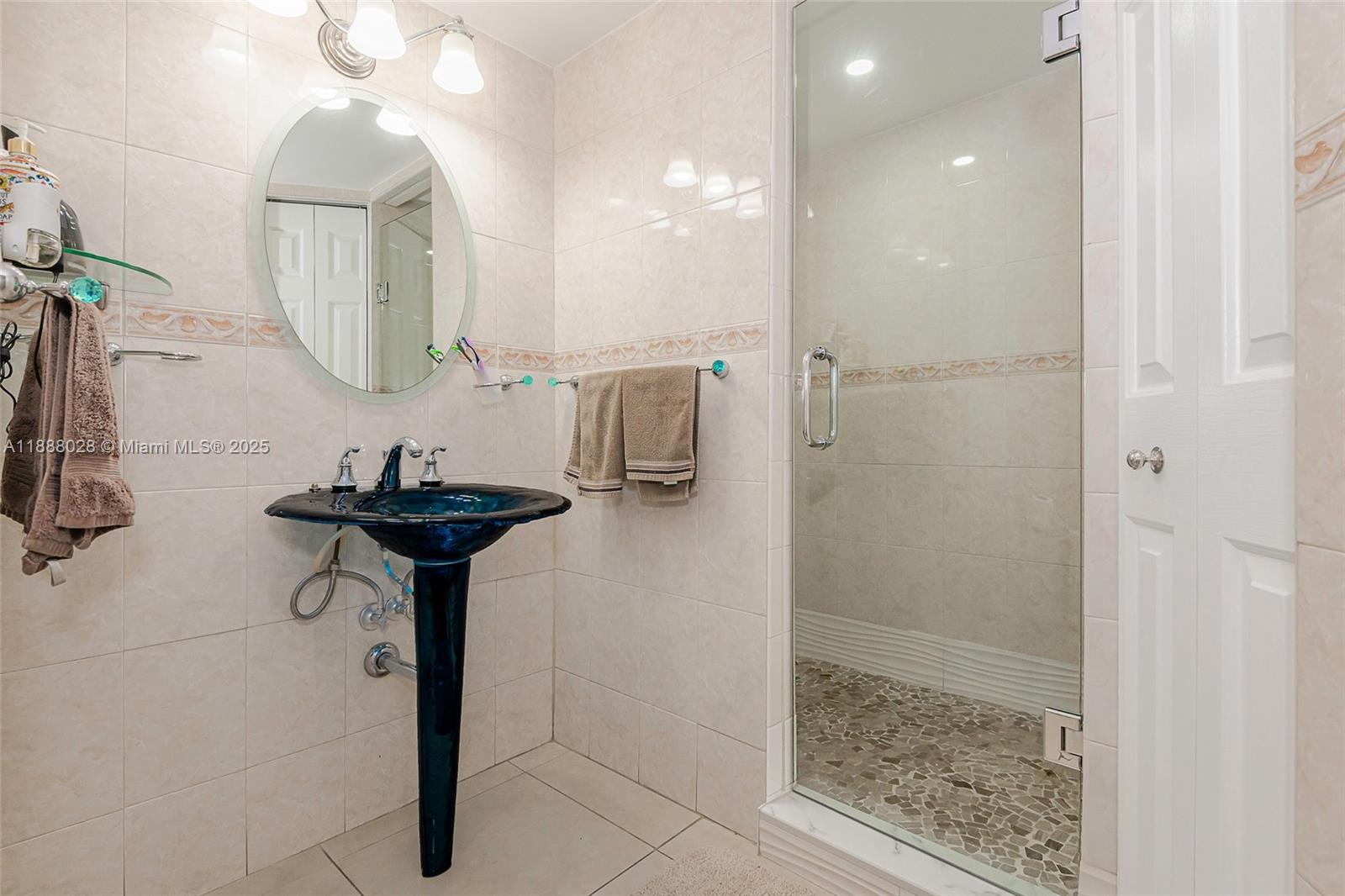 7135 Collins Avenue, Unit 625 Miami Beach, FL 33141 - Photo 27 of 33 a bathroom with a sink and mirror