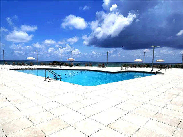 a view of a swimming pool and a yard