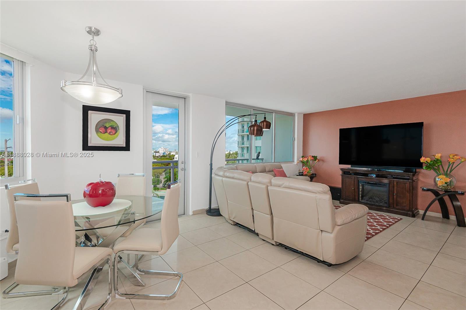 7135 Collins Avenue, Unit 625 Miami Beach, FL 33141 - Photo 7 of 33 a living room with furniture and a flat screen tv