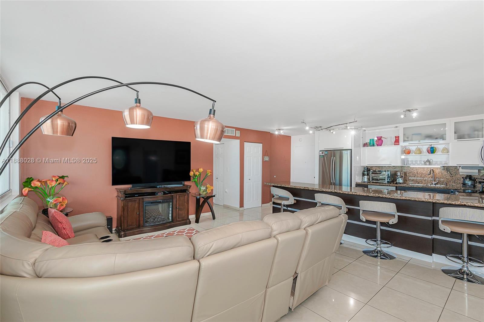 7135 Collins Avenue, Unit 625 Miami Beach, FL 33141 - Photo 9 of 33 a living room with furniture and a flat screen tv