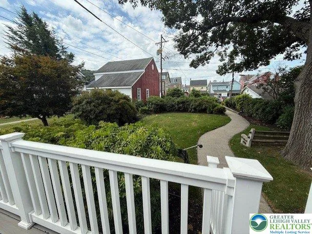 a view of a house with wooden fence