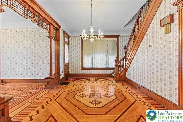 a view of a room with wooden floor and windows