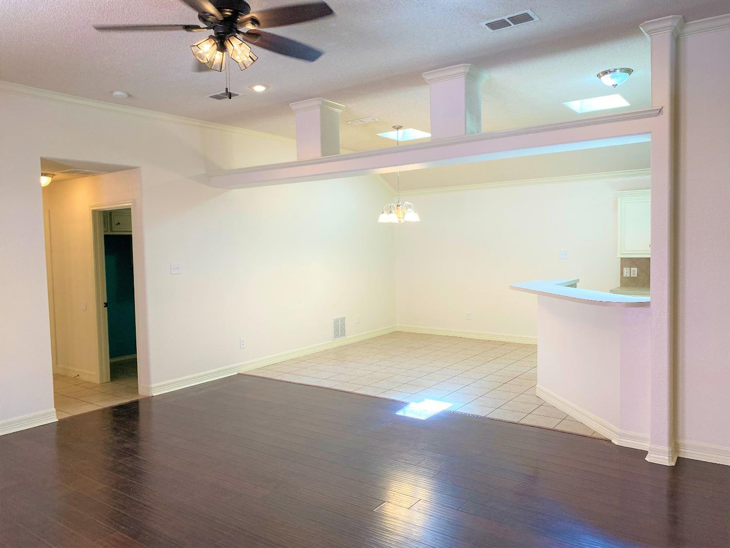 6521 8th Street Lubbock, TX 79416 - Photo 12 of 25 a view of an empty room with wooden floor